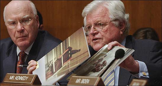 Senators Patrick Leahy of Vermont (left) and Edward M. Kennedy of Massachusetts, displaying photos of abused prisoners, questioned Ashcroft.